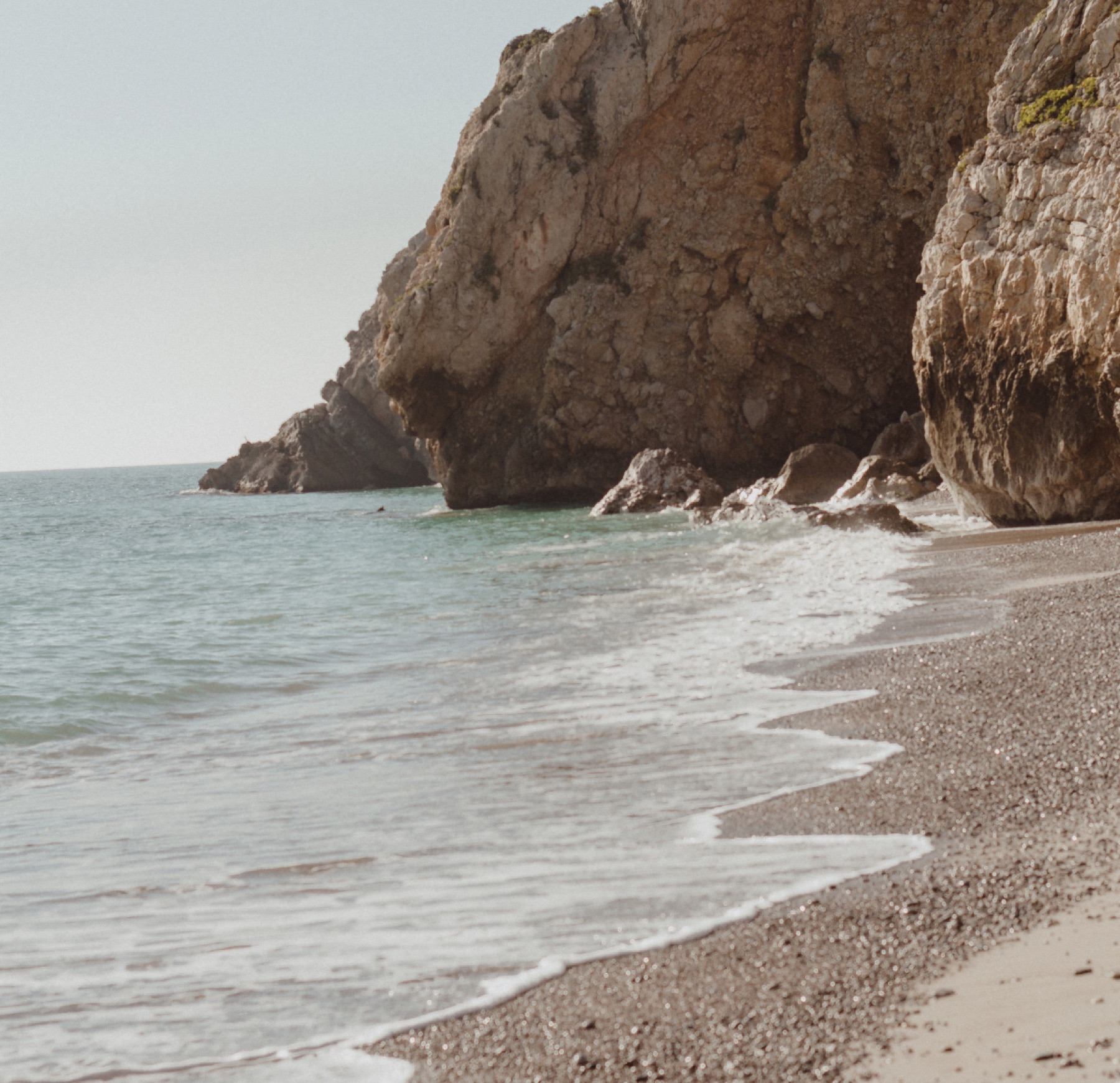 A pebble beach with cliffs