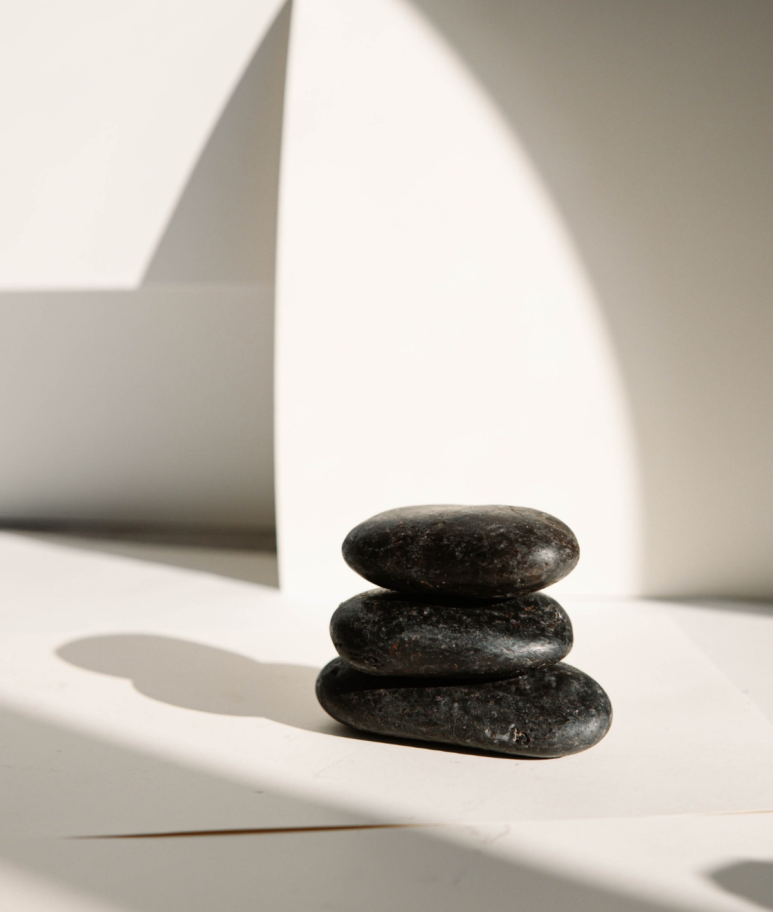 A stack of black stones in soft light